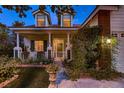 Inviting front porch with white columns, lush greenery, and charming curb appeal at 5513 Flowering Meadows Ave, Las Vegas, NV 89131