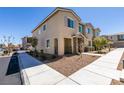 Exterior side view of a modern townhome with low-maintenance landscaping and a bright blue sky at 5730 Sky Pointe Dr # 165, Las Vegas, NV 89130
