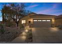 Charming exterior of home at twilight showcases manicured landscaping and a spacious driveway at 6022 Quintillion Ave, Las Vegas, NV 89122