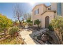 Attractive home with a neatly landscaped front yard featuring a brick walkway and beautiful shrubbery at 6653 Ashley House Ct, Las Vegas, NV 89139