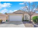 Well-maintained home with attached two-car garage featuring low maintenance desert landscaping and spacious driveway at 7845 Scammons Bay Ct, Las Vegas, NV 89129
