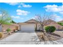 Charming single-story home boasts a well-maintained lawn, desert landscaping, and a two-car garage, perfect for curb appeal at 7845 Scammons Bay Ct, Las Vegas, NV 89129