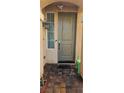 A covered front entrance is highlighted by neutral toned front door and a small window at 8117 Discovery Point St, Las Vegas, NV 89139
