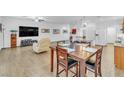 Open-concept living and dining area with tile floors, white walls, and bright, natural light at 8117 Discovery Point St, Las Vegas, NV 89139