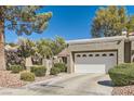 Well-maintained home with desert landscaping, a two-car garage, and a quaint gated entrance at 8628 Desert Holly Dr, Las Vegas, NV 89134