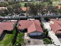 Aerial view of home with a tile roof, desert landscaping, and mature trees at 8641 Surtidor Dr, Las Vegas, NV 89117