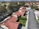 Bird's eye view of the community with mature trees, well-maintained streets, and nearby golf course at 8641 Surtidor Dr, Las Vegas, NV 89117
