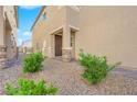 Inviting entrance features a charming porch, landscaped garden and stone accents at 9176 Bluebell Knoll Ct, Las Vegas, NV 89178