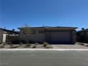 Charming home with a brick driveway and stone accents on the garage at 928 Woodburn Ln, Las Vegas, NV 89138