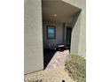 A relaxing front porch with a small table and chairs, perfect for enjoying the outdoors at 928 Woodburn Ln, Las Vegas, NV 89138
