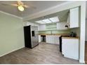 Kitchen featuring stainless steel refrigerator, white cabinets, wood countertops, and gray wood-look floors at , Las Vegas, NV 89103