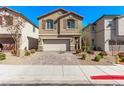 Inviting two-story home with a brick driveway and manicured landscaping at 10160 W Meranto Ave, Las Vegas, NV 89178