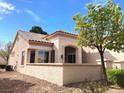 Backyard featuring a covered patio and desert landscaping, perfect for relaxing outdoors at 11031 Mission Lakes Ave, Las Vegas, NV 89134