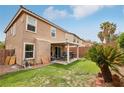 Home featuring a private backyard with a covered patio, lush lawn and mature landscaping at 11620 Longhirst Hall Ln, Las Vegas, NV 89138