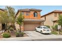 Two-story home showing front yard with desert landscaping and large driveway, attached two-car garage at 11620 Longhirst Hall Ln, Las Vegas, NV 89138