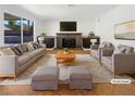 Bright living room featuring a cozy fireplace and stylish, neutral toned furniture at 132 Montclair Dr, Henderson, NV 89074