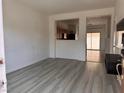 Bright living room with light vinyl floors, open to the kitchen and access to the backyard at 1820 Peridot Point St, Las Vegas, NV 89106