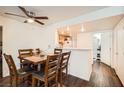 Cozy dining area featuring a wood table with chairs, flowing into an open kitchen, with hardwood style flooring at 1830 N Pecos Rd # 137, Las Vegas, NV 89115