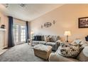 Comfortable living room with plush seating, soft lighting, and a cozy fireplace for relaxation at 209 Crosswind Way, Las Vegas, NV 89145