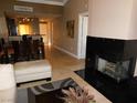Bright living room with modern fireplace, tile floors, and comfortable seating at 260 E Flamingo Rd # 404, Las Vegas, NV 89169