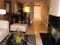 Open living space featuring a fireplace and dining area with granite countertops at 260 E Flamingo Rd # 404, Las Vegas, NV 89169
