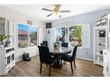 Dining room with wood floors, windows with shutters, and a table set for dinner at 2606 Crested Butte St, Henderson, NV 89052