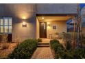Inviting front entrance with a cozy sitting area and brick pathway surrounded by lush landscaping at 2669 Via Monet, Henderson, NV 89044