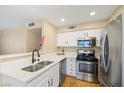 Upgraded kitchen features stainless steel appliances and sleek quartz countertops at 3123 Key Largo Dr # 101, Las Vegas, NV 89120
