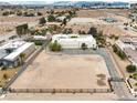 An aerial view highlights the expansive lot, desert surroundings, and three-car garage of the featured residence at 3910 W Pebble Rd, Las Vegas, NV 89139