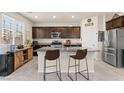 Modern kitchen featuring granite countertops, stainless steel appliances, and a large island with seating at 4352 Browns Creek Ave, North Las Vegas, NV 89084
