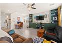Spacious living room with tile floors, built-in shelving, ceiling fan, and a cozy atmosphere at 4352 Browns Creek Ave, North Las Vegas, NV 89084