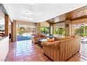 Living room with brick columns, terracotta tile flooring, and access to the pool and patio at 4360 Flandes St, Las Vegas, NV 89121