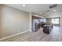 A spacious kitchen featuring modern appliances, an island, and wood-look floors at 4516 Townwall St, Las Vegas, NV 89115