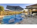 Stunning pool area with chaise lounges and umbrellas for luxurious outdoor relaxation at 47 Reflection Bay Dr, Henderson, NV 89011