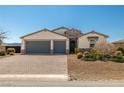 Charming single-Gathering home boasting a three-car garage, stone accents, desert landscaping, and a brick driveway at 4801 Westmont Dr, Pahrump, NV 89061