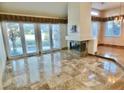 Spacious living room featuring elegant tile flooring and a cozy fireplace at 5010 Longboat Cir, Las Vegas, NV 89113