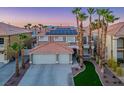Beautiful two-story home features a tile roof, solar panels, a two-car garage, and desert landscaping at 506 Staghorn Pass Ave, Las Vegas, NV 89183
