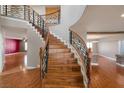 Elegant wooden staircase with decorative iron railing and views of the hardwood floors at 506 Staghorn Pass Ave, Las Vegas, NV 89183