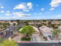Scenic aerial view of a neighborhood with well-maintained homes and lush landscaping under a blue sky at 5107 Morning Splash Ave, Las Vegas, NV 89131