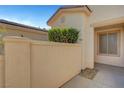 Private courtyard with stucco walls and mature landscaping offers a tranquil outdoor space at 5327 Progresso St, Las Vegas, NV 89135