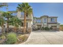 Beautiful two-story home with a three-car garage, stone accents, and lush palm trees at 5337 Polizze Ave, Las Vegas, NV 89141