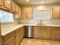 Bright kitchen featuring wood cabinets, stainless steel appliances, and light countertops at 5384 Hanging Tree Ln, Las Vegas, NV 89118