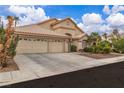 Single-story home with a three-car garage, desert landscaping, and mature trees, showcasing a well-maintained exterior at 5513 Oakview Falls Ct, Las Vegas, NV 89148