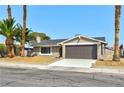 Charming single-story home with a two-car garage and desert landscaping in the front yard at 5804 Maynard Ave, Las Vegas, NV 89108