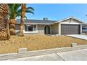 Inviting single-story home with desert landscaping and a two-car garage at 5804 Maynard Ave, Las Vegas, NV 89108