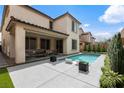 Inviting backyard pool with sleek modern lounge chairs and covered patio area for outdoor relaxation and entertaining at 6545 Vanhoven Crest St, Las Vegas, NV 89166