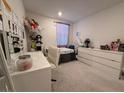 Cozy bedroom with neutral decor and a large window for natural light at 6999 Bard Ave, Las Vegas, NV 89113