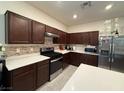 Modern kitchen with stainless steel appliances and white countertops at 6999 Bard Ave, Las Vegas, NV 89113