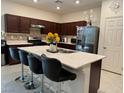 Modern kitchen featuring stainless steel appliances and an island with seating at 6999 Bard Ave, Las Vegas, NV 89113