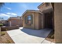 Close up of single-story house entrance with stone veneer accents and desert landscaping at 703 Flaming Cliffs Ct, Henderson, NV 89014